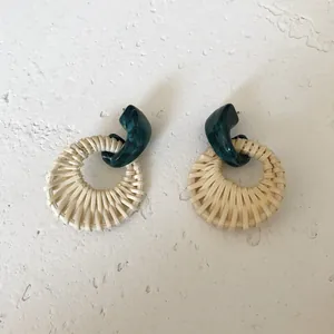 Detail of teal marble resin stud and hand-woven beige rattan ring drop earring