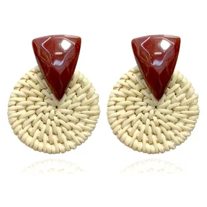 Bohemian triangle resin and round rattan woven earrings on a clean white background