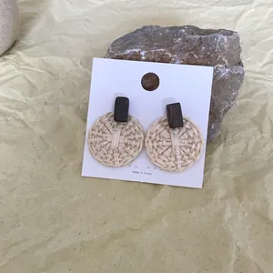 Bohemian round woven rattan drop earrings with wood detail on white display card