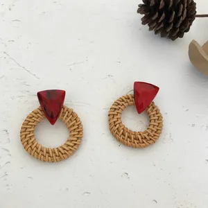 Rattan woven hoop earrings with red marble resin triangle in a natural rustic style