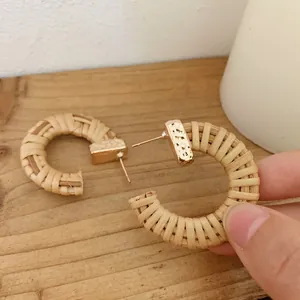 Bohemian C-shaped handmade rattan woven hoop earrings with hammered gold metal details