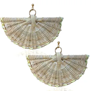 Close-up of bohemian woven rattan fan-shaped earrings with gold ball studs on white