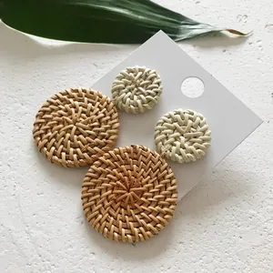 Detail van handgemaakte rotan hangers in bruin en crème op een presentatiekaart