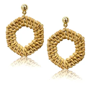 Detailed view of woven rattan hexagon drop earrings with gold metallic accents