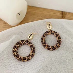 Bohemian rattan hoop earrings with leopard print, shell accents and gold ear hooks