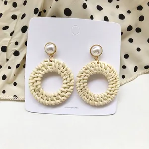 Handmade rattan hoop earrings with pearl stud details and golden accents for summer
