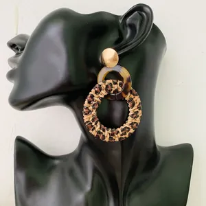 Bohemian leopard print hand-woven rattan drop earrings with gold studs and tortoise ring