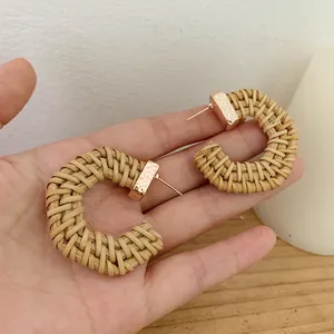Handmade bohemian geometric rattan woven C-shaped earrings with gold textured metal details