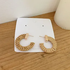 Handmade Bohemian C-shape woven rattan earrings with gold textured rectangle studs
