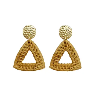 Bohemian rattan drop earrings with textured gold metal studs and woven triangles