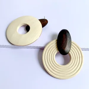 Macro shot of geometric wooden hoop earrings with concentric rings and natural textures
