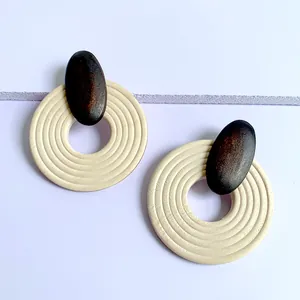 Detail view of bohemian large wooden earrings featuring concentric textured circles