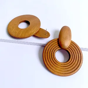 Macro view of geometric wooden hoop earrings with natural grain and spiral texture details