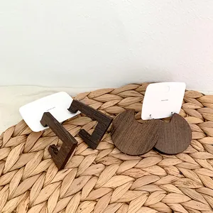 Retro geometric wooden hoop earrings with dark wood grain texture on card