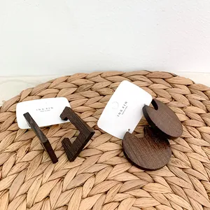 Detail view of rectangular and circular dark wood earrings on display cards