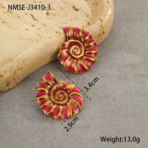 Detailed view of pink enamel conch earrings with 18K gold plated stainless steel edges