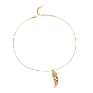 Golden stainless steel horn pendant necklace with colorful zircon stones on white background
