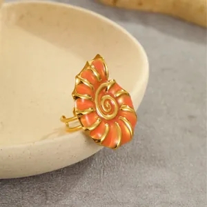 Detailed view of an 18K gold-plated nautilus ring with vibrant orange enamel inlay