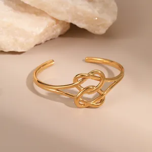 Minimalist 18K gold-plated open bangle with twisted knot heart design on stone