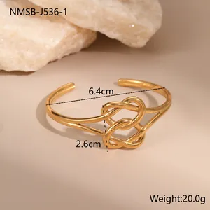 18K gold plated stainless steel open bangle featuring a unique double knot heart design