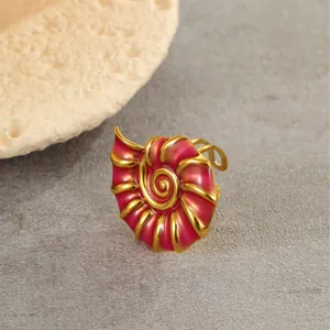 Macro shot of 18K gold-plated seashell ring with deep red enamel inlay detail
