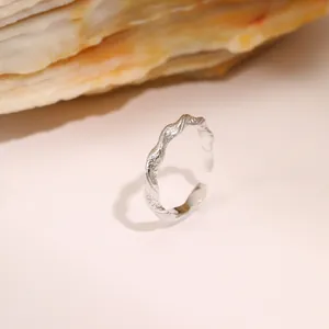 Detail view of silver titanium steel ring with organic hammered texture on stone base