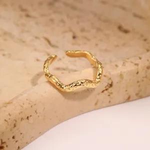 Macro shot of gold adjustable wave ring featuring unique hammered lava texture finish