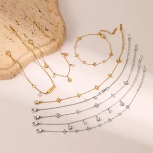 Macro shot of 18k gold and silver plated star pendants with sparkling zircons on steel bracelets