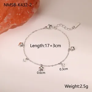 Detailed macro view of star charms and zircons on a gold-plated stainless steel chain