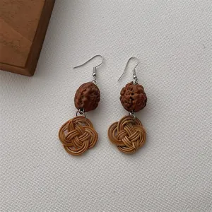 Ethnic handmade drop earrings with natural wood beads and brown woven rattan knots
