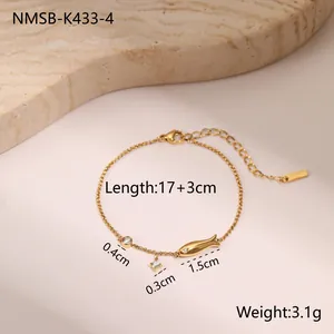 Detail of 18k gold plated titanium chain with zircon charms and fish pendant