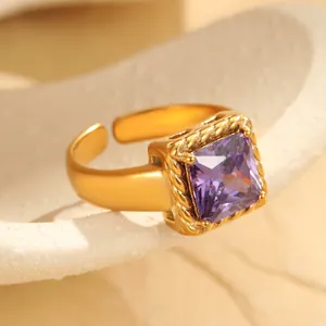 Detailed macro view of gold plated ring with square purple zircon and twisted edge