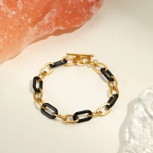 Bracelet chaîne en acier inoxydable doré et résine noire avec fermoir à bascule OT