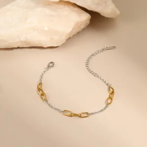 Detail of two-tone gold and silver chain bracelet with lobster clasp and extender