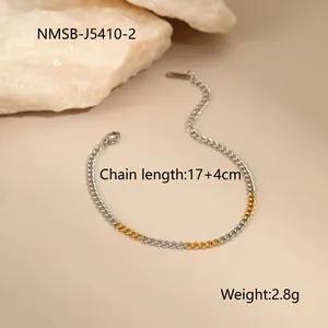 Detail of two-tone gold and silver stainless steel curb chain bracelet with lobster clasp