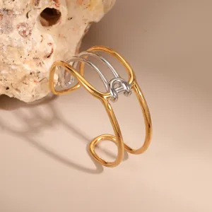Minimalist open adjustable bangle with two-tone gold and silver interlocking geometric lines