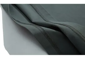 Detailed close-up of tight stitching and high-quality dark grey-green cotton fabric seam