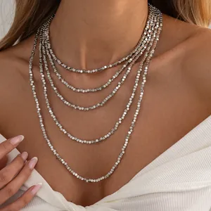 Detailed view of silver square CCB beaded layered necklace worn on a fashion model