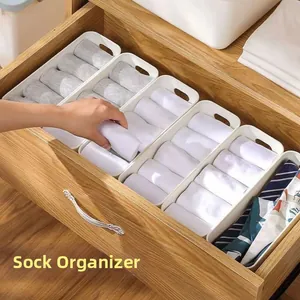 Detail view of white rectangular drawer organizers for socks and small items