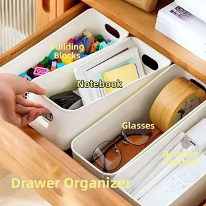 White rectangular drawer dividers for organizing toys, notebooks, and remote controls