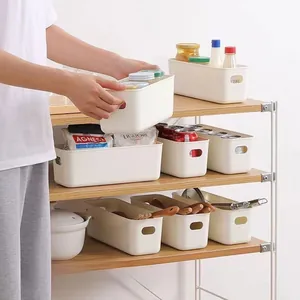 Close-up of matte white plastic drawer organizer boxes for kitchen and office storage