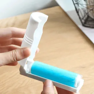 Portable mini lint roller with foldable design for pet hair removal on wooden surface