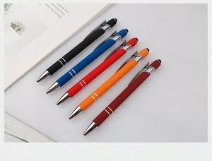 Close-up of set of five colorful metal pens with stylus tips on a minimalist desk