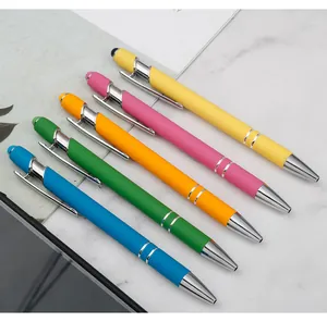 Detailed view of colorful 2-in-1 stylus ballpoint pens on a modern marble background