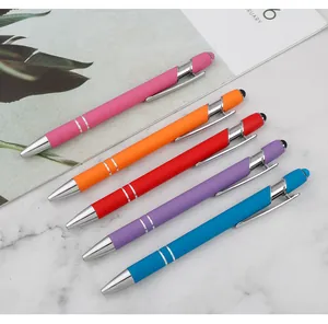 Detailed close-up of 5 colorful stylus ballpoint pens with silver clips on marble surface