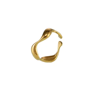 Minimalist gold wavy open ring with organic curved shape and polished mirror finish