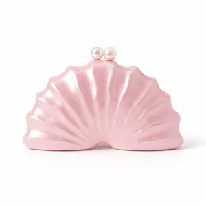Détail d'une pochette coquillage rose avec fini nacré et fermoir à doubles perles