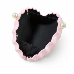 Pochette de soirée coquillage rose avec fermoir perle et doublure noire à poche