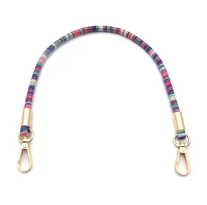 Rainbow woven bag handle with gold lobster clasps and colorful striped pattern strap