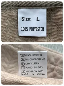 Detailed clothing care label on waffle knit fabric showing 100% polyester material and size L
